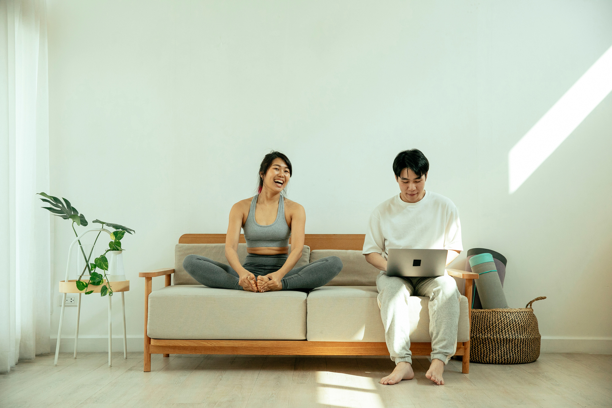 Asian couple on sofa in living room