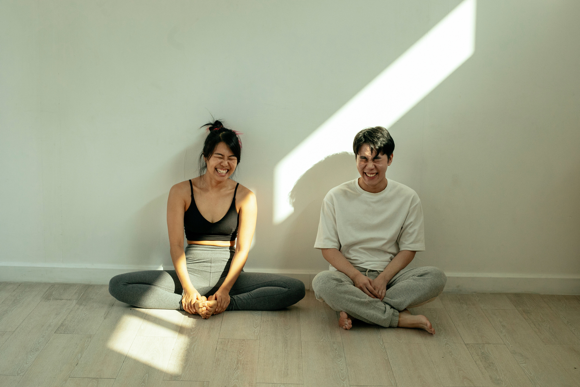 Couple laughing and sitting on floor