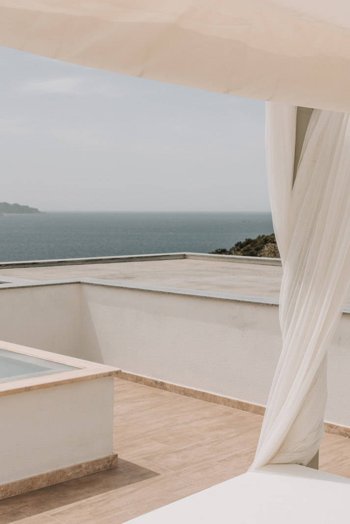 Bed With White Curtain Beside A Pool