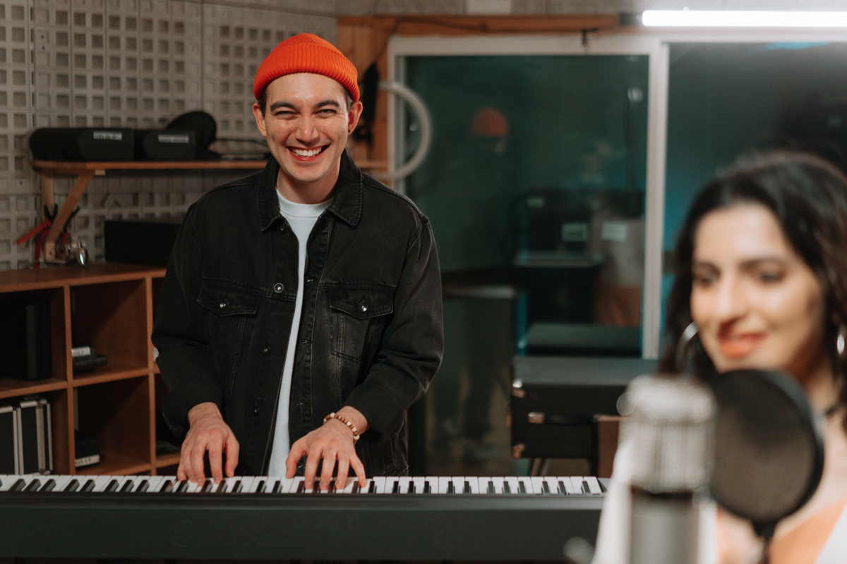 A Man Playing Piano inside a Music Studio